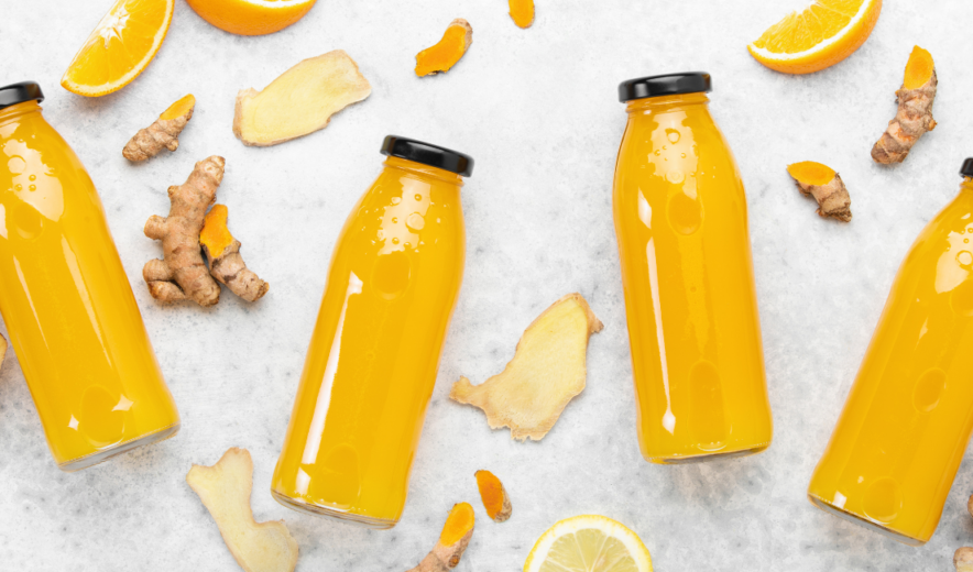 Bottled ginger turmeric shots with orange and lemon – natural health drink for immunity boost