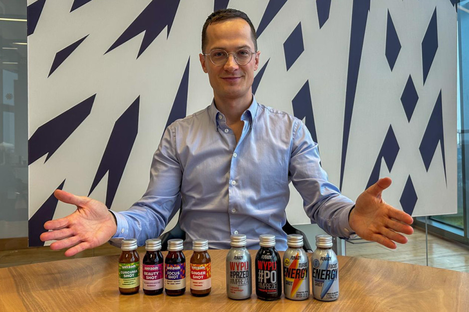 CEO of Chias Brothers presenting a lineup of functional shots including ginger, turmeric, energy and focus drinks, sitting at a table in a modern office setting.