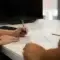 Two people reviewing a printed due diligence checklist at an office desk